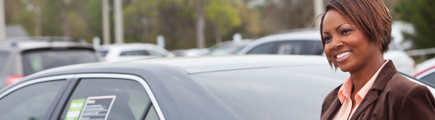 Woman looking at new and used cars